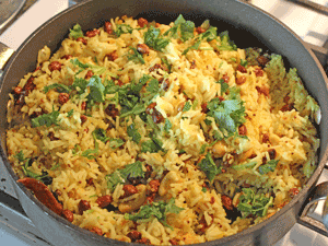 The ingredients are now added to the cooked rice and mixed well