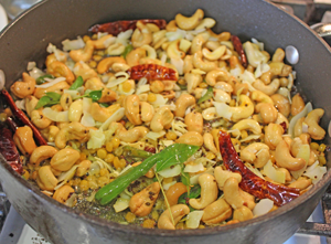  Cashew nuts added to Lemon rice ingredients cooking on stove